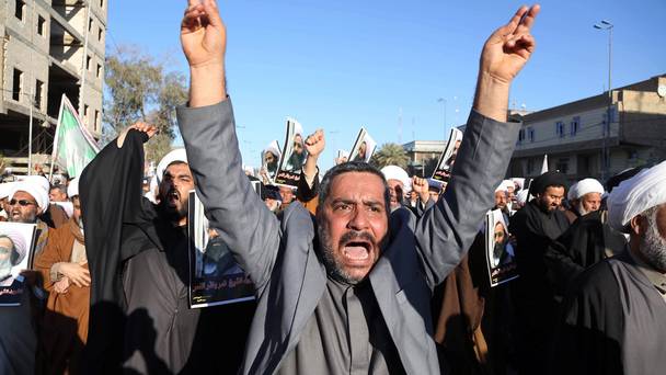 Iraqi Shiite protesters chant slogans against the Saudi government as they hold posters showing Sheikh Nimr al-Nimr who was executed in Saudi Arabia last week