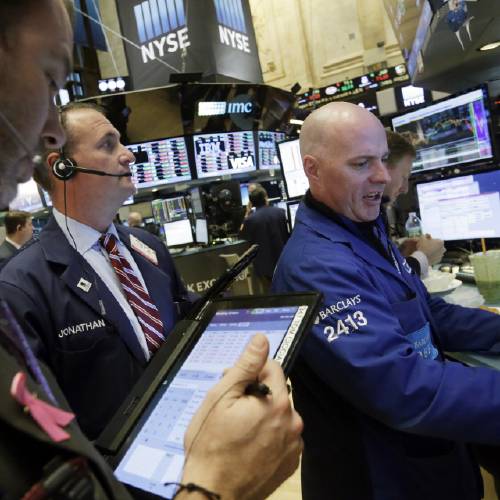 O'Hara right works with traders at his post on the floor of the New York Stock Exchange Thursday Jan. 14 2016. U.S. stocks moved slightly lower in early trading Thursday extending losses following the worst market drop