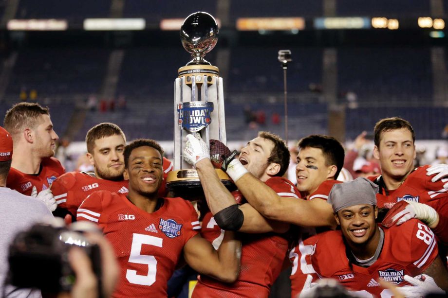 Wisconsin players hold the Holiday Bowl trophy after defeating Southern California in the Holiday Bowl NCAA college football game Wednesday Dec. 30 2015 in San Diego. Wisconsin won 23-21