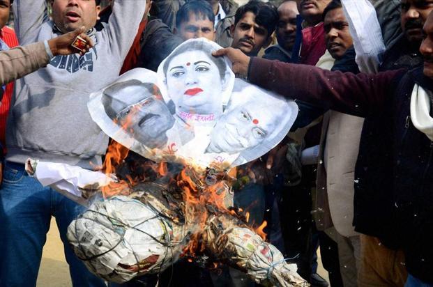 Protestors burn an effigy of UoH Vice Chancellor Appa Rao HRD minister Smriti Irani and union labour minister Bandaru Dattatreya during a protest rally