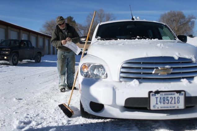 The stolen vehicles had signs for the Harney County Resource Center the name that the occupiers have given to Malheur National Wildlife Refuge. Above Medenbach puts up a sign on Friday