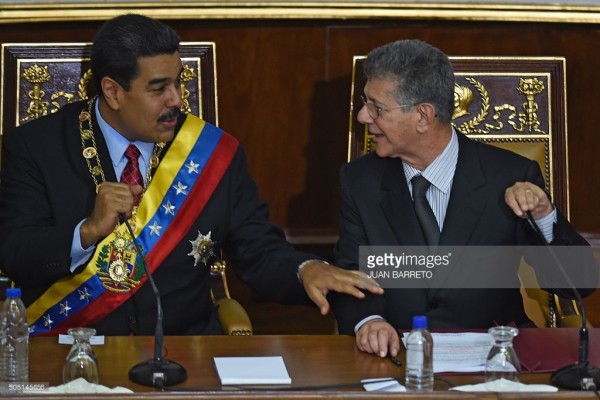 Venezuelan President Nicolas Maduro speaks with the president of the National Assembly opposition Henry Ramos Allup, during his annual report at the National Assembly