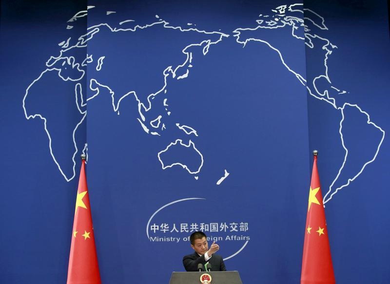 Chinese Foreign Ministry spokesman Lu Kang points out a reporter to receive a question at a regular news conference in Beijing