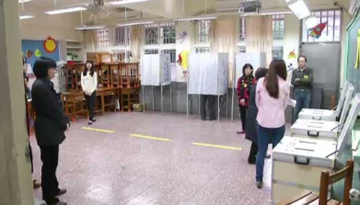 Voters in Taiwan make their selections on Saturday. Voter turnout is estimated to be about 70 percent