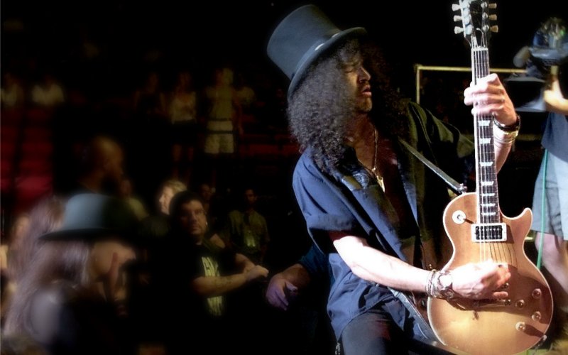 Guitarist Slash of Guns N&#39 Roses fame straddles the barricade as he performs at the Thomas & Mack Center in Las Vegas