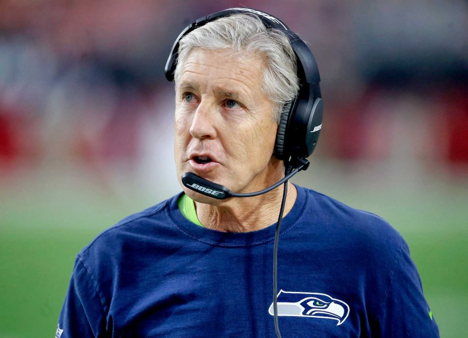 Seattle Seahawks head coach Pete Carroll makes a call during the first half of an NFL football game against the Arizona Cardinals Sunday Jan. 3 2016 in Glendale Ariz