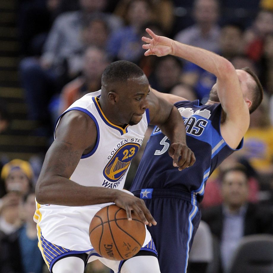 Draymond Green fouls JJ Barea in the second half as the Golden State Warriors played the Dallas Mavericks at Oracle Arena in Oakland Calif. on Wednesday