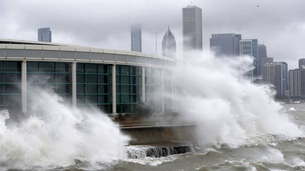 Waves from Lake Michigan smash against Chicago's Shedd Aquarium as the winter storm moves across Illinois