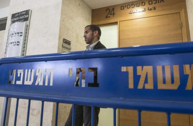 Israeli security block the entrance to the Petah Tikva Justice court where suspects in the brutal murder of a Palestinian teenager who was burned to death in a suspected revenge killing. are held for a hearing