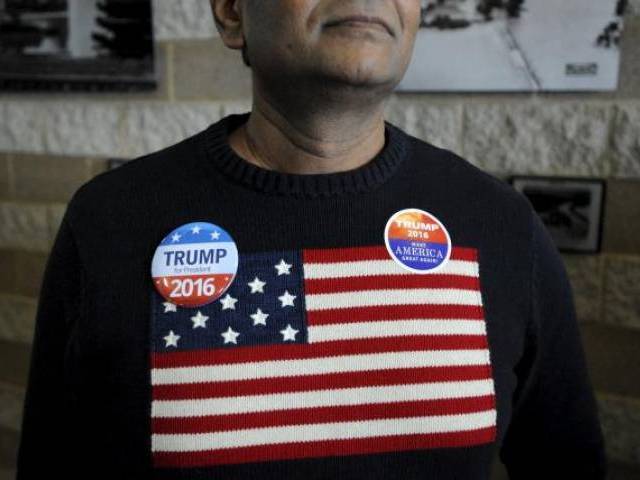 A supporter of U.S. Republican presidential candidate Donald Trump waits to enter the auditorium at the Bridge View Center ahead of a campaign event in Ottumwa Iowa