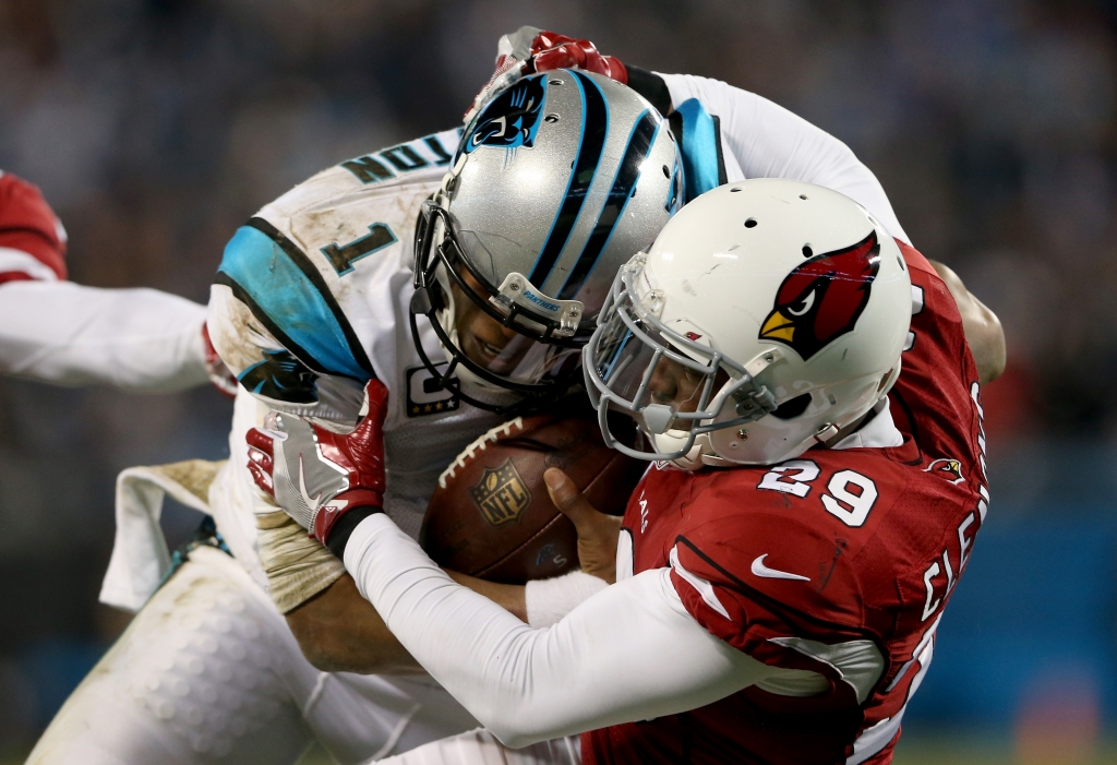 CHARLOTTE NC- JANUARY 24 Chris Clemons #29 of the Arizona Cardinals tackles Cam Newton #1 of the Carolina Panthers in the second half during the NFC Championship Game at Bank of America Stadium