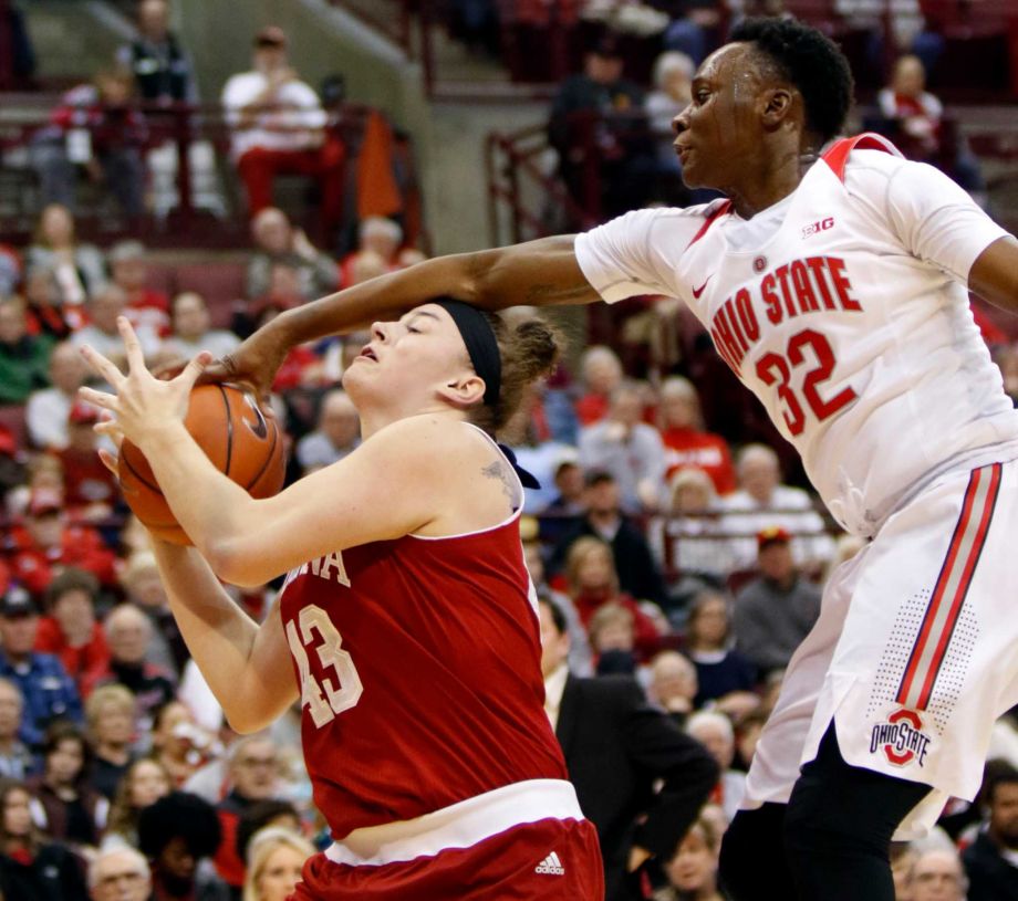 Ohio State's Shayla Cooper right reaches for the ball against Indiana's Jenn Anderson during the first half of an NCAA college basketball game in Columbus Ohio Thursday Jan. 7 2016