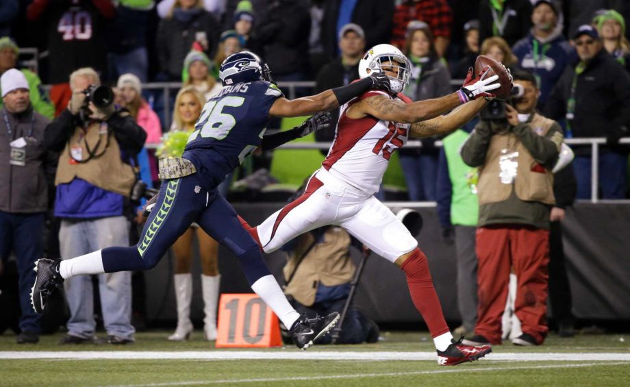 Arizona Cardinals wide receiver Michael Floyd catches a pass for a touchdown as Seattle Seahawks cornerback Cary Williams defends during the first half of an NFL football game in Seattle. On a Sunday night seven