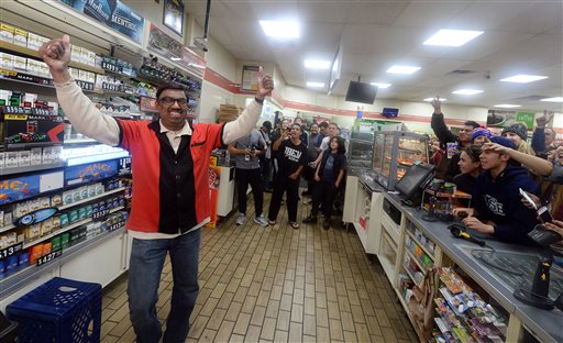 7-Eleven store clerk M. Faroqui celebrates after learning the store sold the only winning Powerball ticket on Wednesday Jan. 13 2016 in Chino Hills Calif. One winning ticket was sold at the store located in suburban Los Angeles said Alex Traverso a