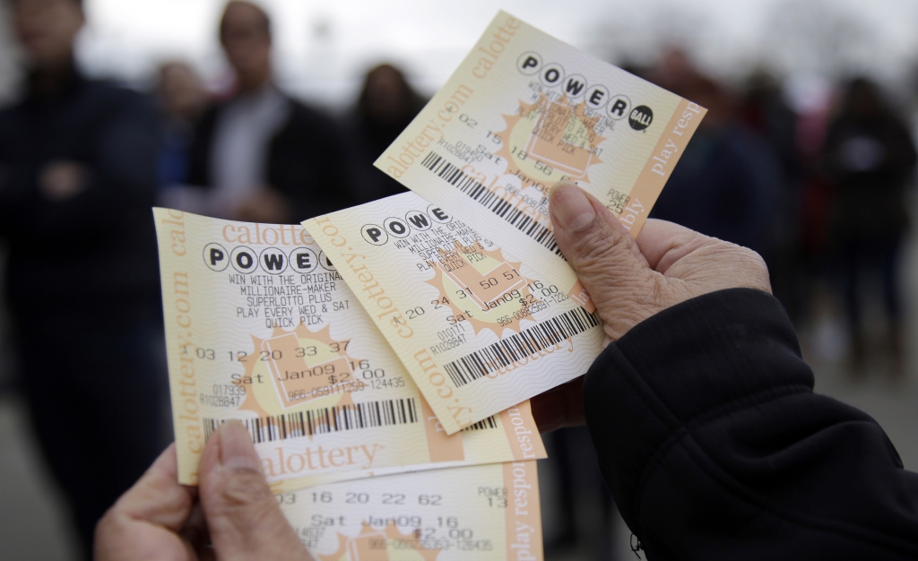 People play various lottery games at a store in New York Monday Jan. 11 2016. Lottery officials say the Powerball jackpot has grown to more than a billion