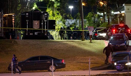 Authorities work the scene of a standoff at the Rite4 Us Inn and Suites on Snapfinger Woods Drive Tuesday Jan. 5 2016 in Decatur Ga. A standoff at a motel outside Atlanta that involved a number of children ended Tuesday morning with the suspect sta