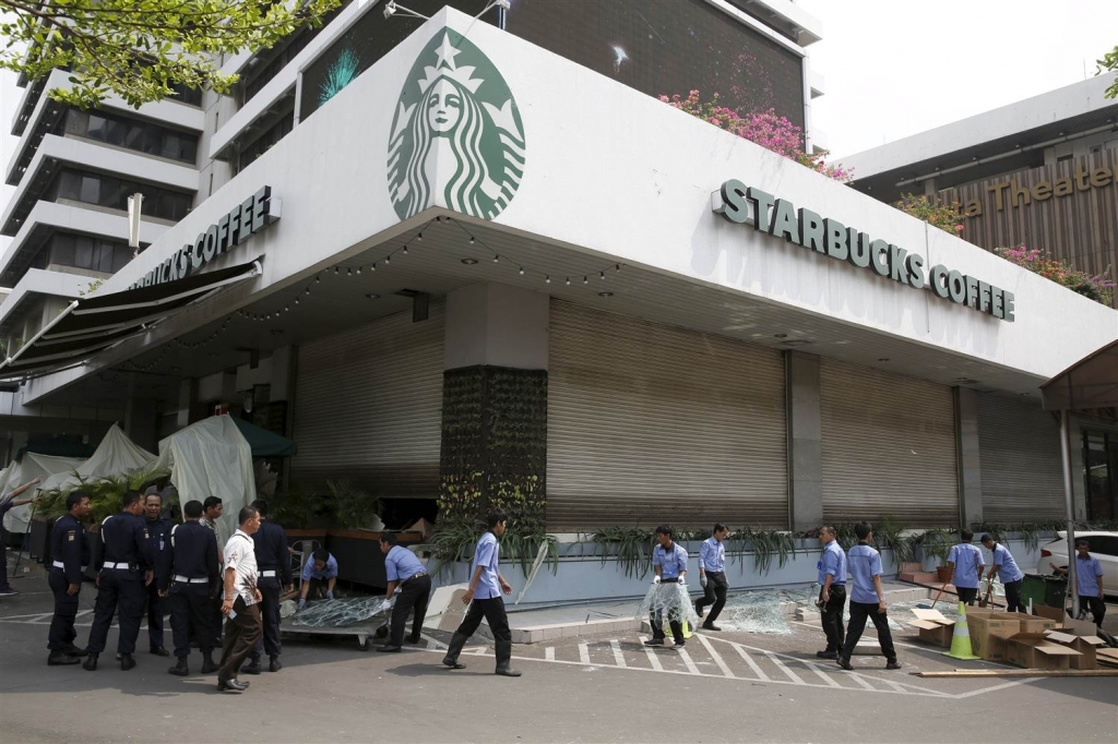 Image Workers clean debris outside a Starbucks cafe near the site of a militant attack in Jakarta