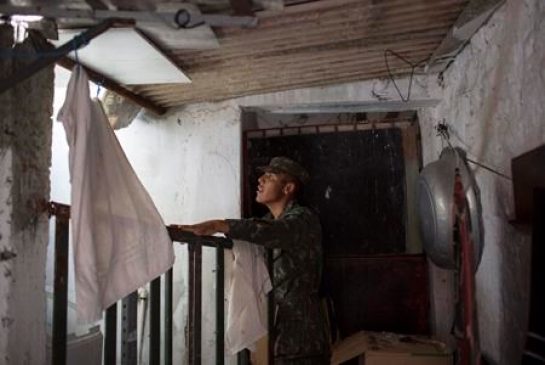 A Brazilian Army soldier inspects a house during an operation to combat the Aedes aegypti mosquitoes that transmits the Zika virus in Recife Pernambuco state Brazil Tuesday Jan. 26 2016