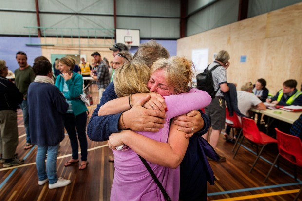 Wye River locals comfort each other at the Apollo Bay Relief Centre