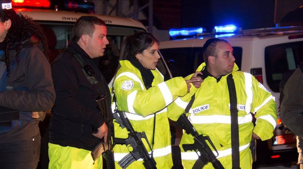 Police officers at the scene of a terror attack in which two people were wounded by two Palestinian stabbers in the West Bank settlement of Beit Horon on Monday January 25 2016