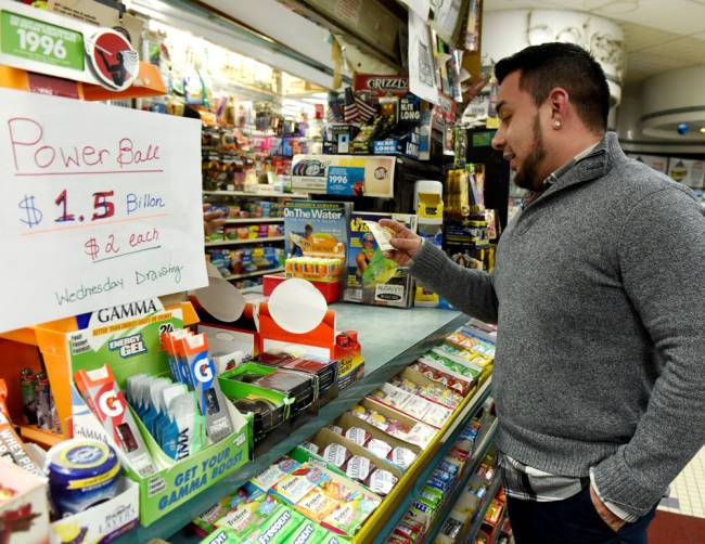 Jorge Falconi checks out his Powerball tickets at Simply Elegant Super Deli in Hawthorne on Tuesday Jan. 12 2016