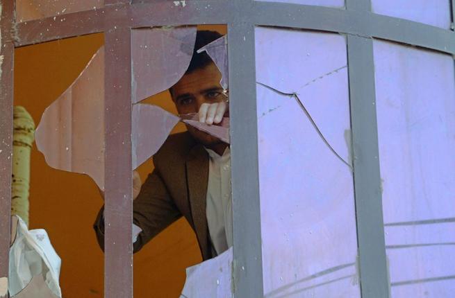 The Pakistani consulate is the second attack in Jalalabad this week. Here a man peers through the broken glass of the bombed Indian embassy on January 5