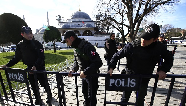 Policemen install security barriers at the historic Sultanahmet district which is popular with tourists after an explosion in Istanbul Tuesday Jan. 12 2016. Turkish media reports say several people have been injured in the explosion. (AP