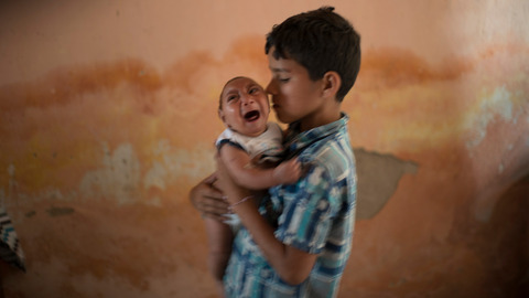 10-year-old Elison nurses his 2-month-old brother Jose Wesley who was born with microcephaly