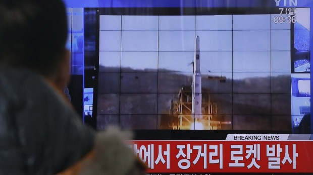 A South Korean man watches a TV news report on North Korea's rocket launch at Seoul Railway Station