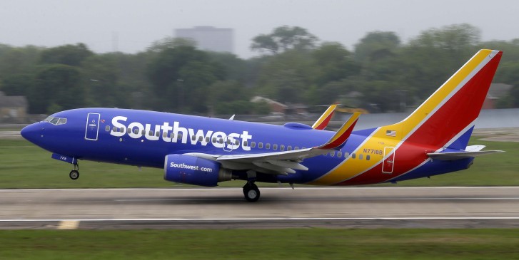 A Southwest airlines jet takes off from a runway at Love Field in Dallas Thursday