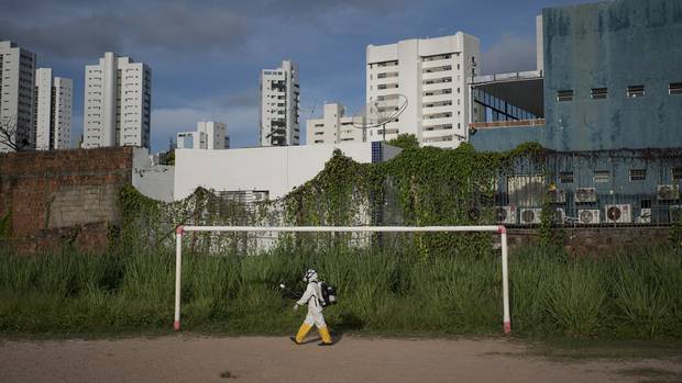 A health worker sprays insecticide at a sports centre in Recife