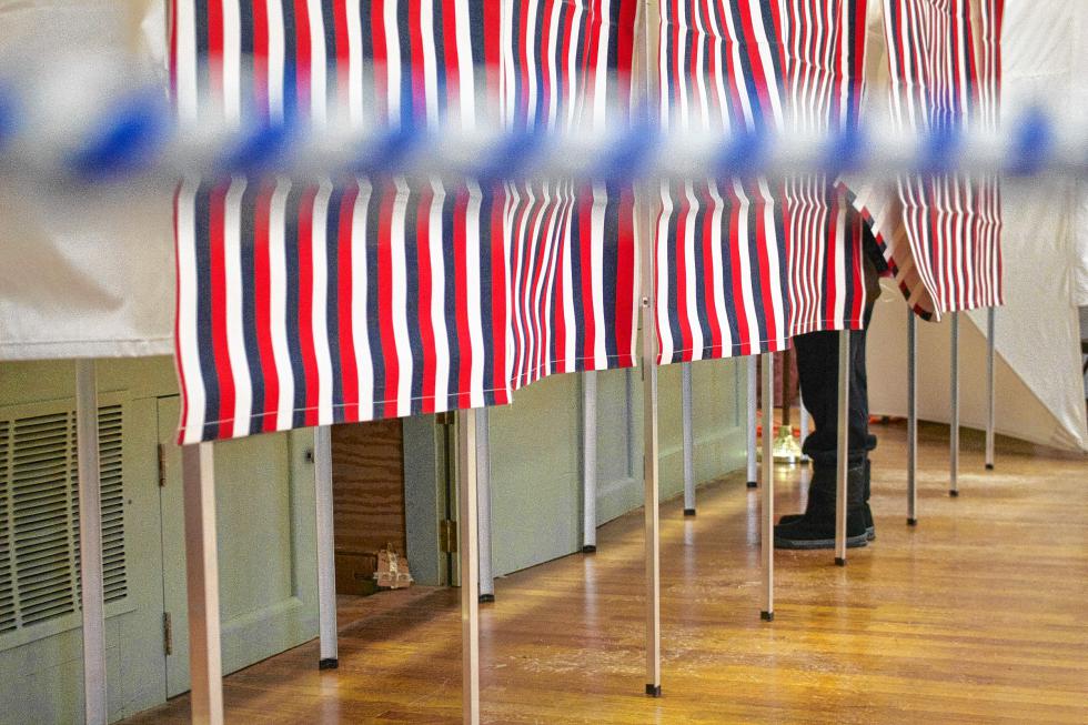 A voter stands in a booth at Webster Town Hall.- Elodie Reed  Monitor staff