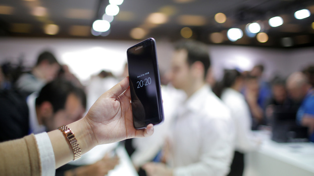 A woman holds the new Samsung Galaxy S7 during the Mobile World Congress in Barcelona