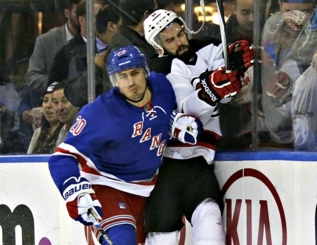 Rangers&#39 Chris Kreider checks Devils&#39 David Schlemko in the second period Monday