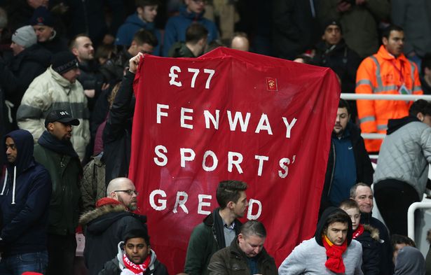 Liverpool fans hold up a sign in protest against ticket prices