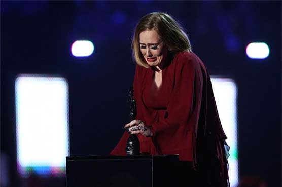 Adele took to the stage in tears saying'My kid is going to think I'm so cool