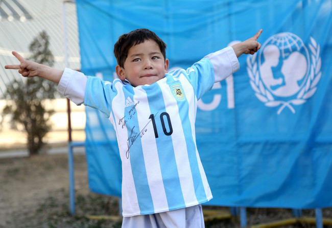 In this provided by UNICEF Murtaza Ahmadi an Afghan Lionel Messi fan shows a donated and signed shirt by Messi in Kabul Afghanistan Thursday Feb. 25 2016