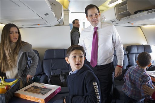 Republican presidential candidate Sen. Marco Rubio R-Fla. boards a plane with his family and staff to leave Manchester N.H. Wednesday Feb. 10 2016 en route to South Carolina after the New Hampshire primary. With him is daughter Amanda Rubio 15