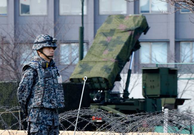 A Japan Self Defense Force member stands by a PAC-3 Patriot missile unit deployed for North Korea's rocket launch at the Defense Ministry in Tokyo Sunday Jan. 31 2016