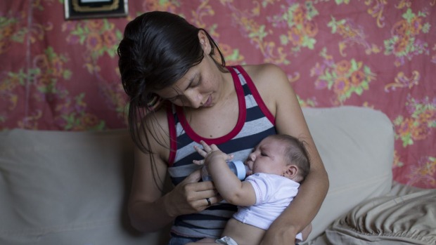 Angelica Pereira feeds her daughter Luiza who was born with microcephaly in Santa Cruz do Capibaribe Brazil