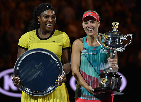 TOPSHOT- Germany's Angelique Kerber holds The Daphne Akhurst Memorial Cup as she celebrates after victory her women's singles final match against Serena Williams of the US on day thirteen of the 2016 Australian Open tennis tournament in Melbourne