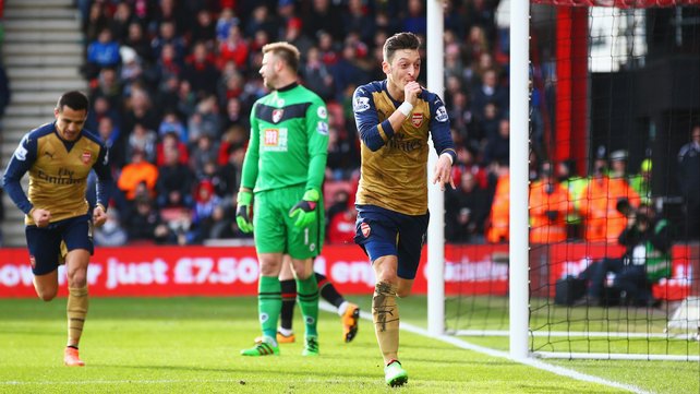 Artur Boruc looks dejected as Mesut Ozil celebrates his goal