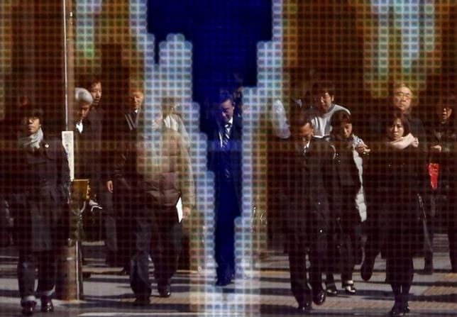 Pedestrians are reflected in an electronic board showing the graph of the recent fluctuations of the exchange rates between the Japanese yen against the U.S. outside a brokerage in Tokyo Japan