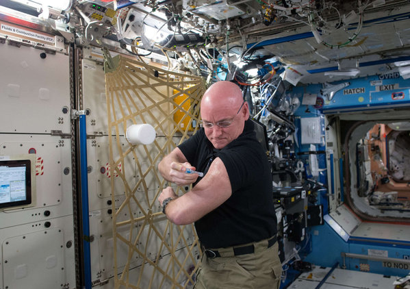 Astronaut Scott Kelly giving himself a flu shot on Sept. 24 2015 aboard the International Space Station is due to return this week after a 340-day mission