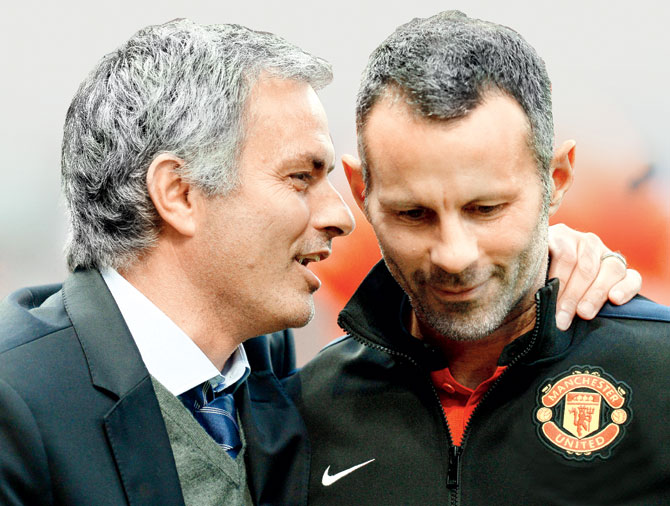 Chelsea manager Jose Mourinho speaks to Man United midfielder Ryan Giggs before their EPL match at Old Trafford. Pic  AFP