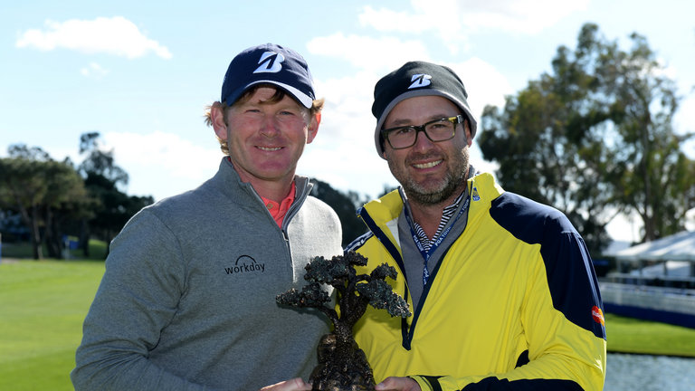 Brandt Snedeker and caddie Scott Vail pose with the winner's trophy