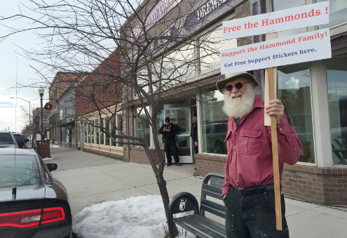 Kim Rollins 64 of Burns stands outside the Harney County Community Center in Burns Ore. before the start of a news conference by officials on Jan. 24. Authorities on Jan. 23 arrested the leaders of an armed group who had been occupying the Malheur Na