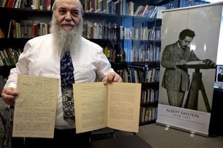 Hebrew University's Roni Gross holds the original historical documents related to Albert Einstein's prediction of the existence of gravitational waves at the Hebrew university in Jerusalem Thursday Feb. 11 2016. In a blockbuster announcement