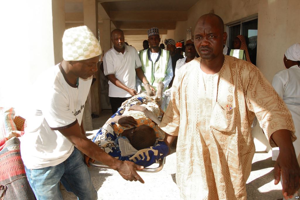 Rescue workers transport a victim of a suicide bomb attack at a refugee for treatment at a hospital in Maiduguri Nigeria Feb. 10 2016. Credit VOA  AP