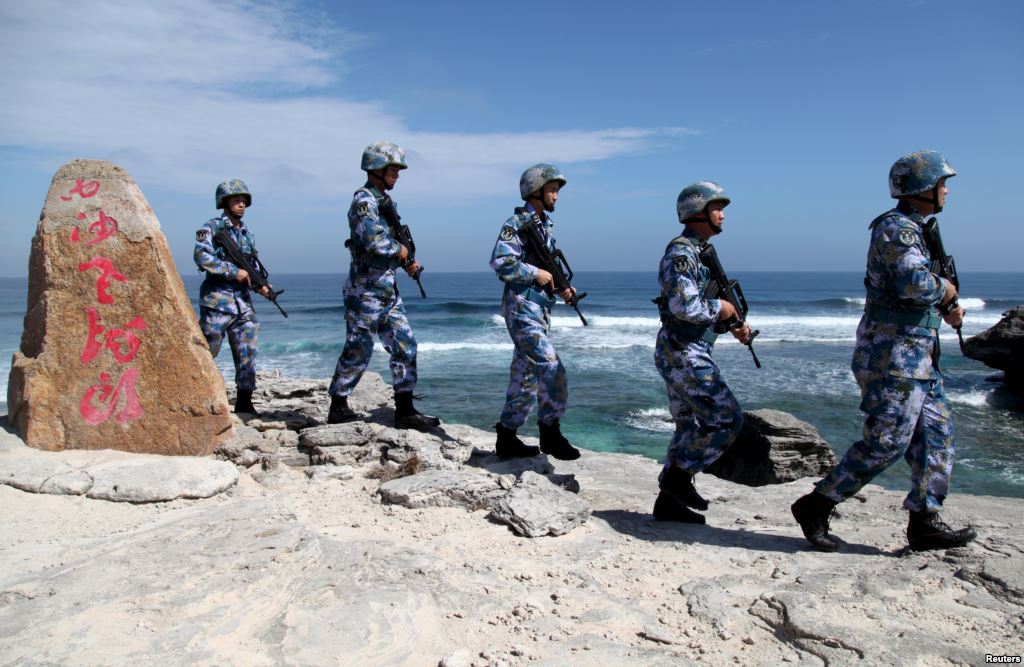 FILE- Soldiers of China's People's Liberation Army Navy patrol at Woody Island in the Paracel Archipelago which is known in China as the Xisha Islands Jan. 29 2016. Fewer than 10 jets – a combination of Shenyan J-11 and Xian JH-7 airc